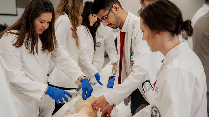 TTUHSC Amarillo general surgery residents collaborating on a clinical skills exercise with faculty supervision.