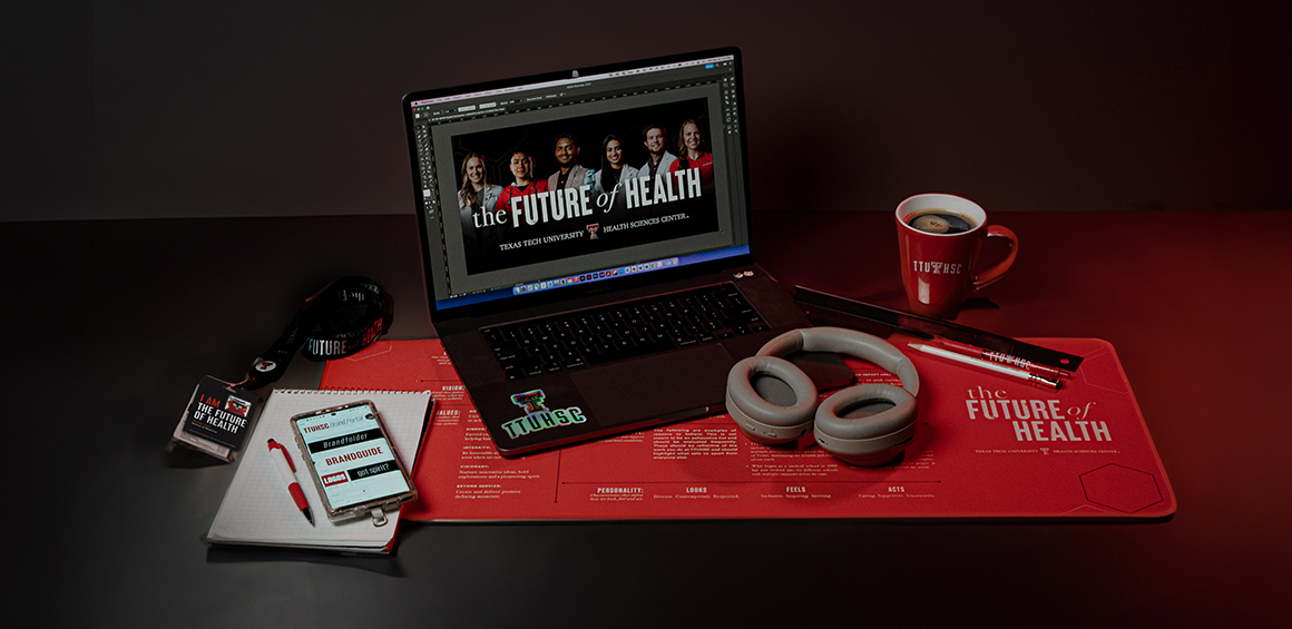 table with laptop and phone showing a lot of the branding of TTUHSC