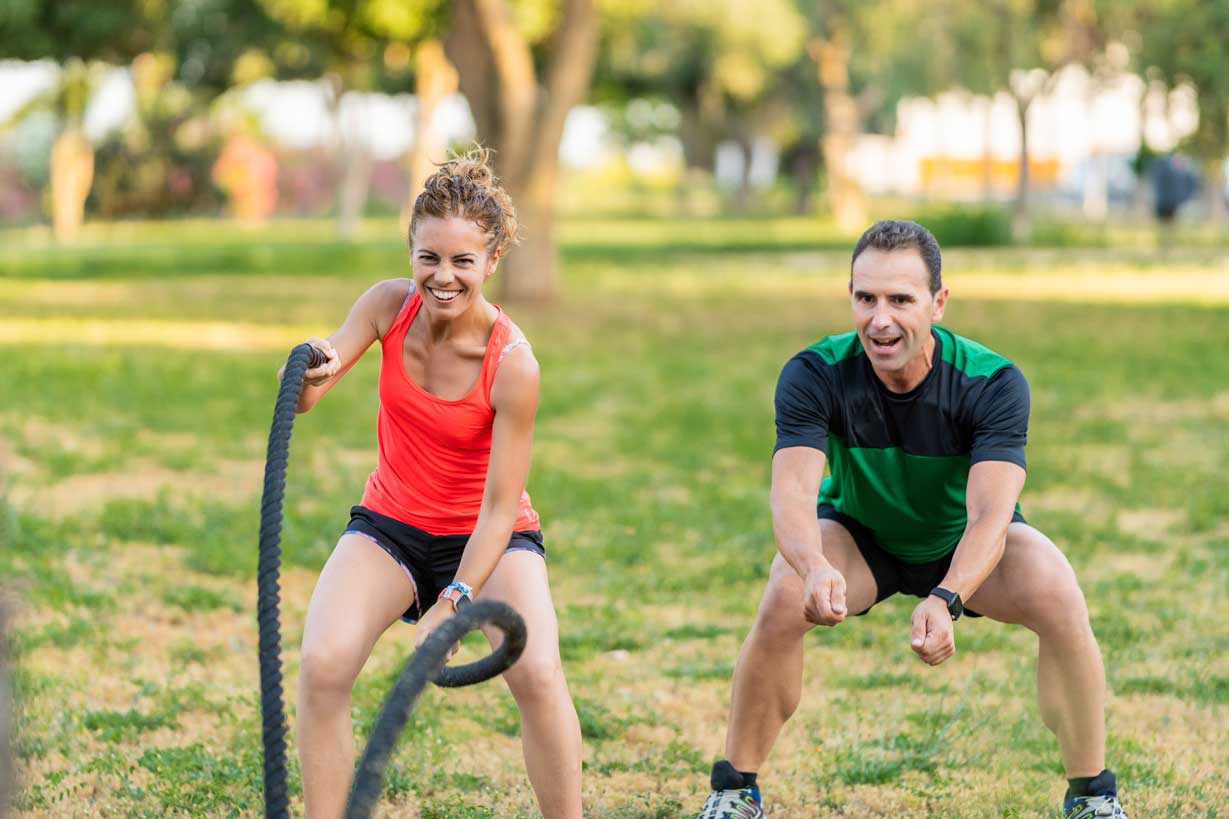 woman smiling and exercising intensely