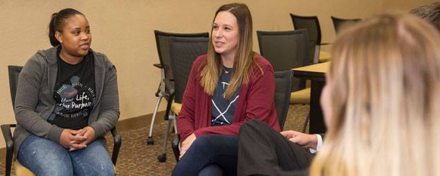 A licensed mental health counselor holds a group counseling session.