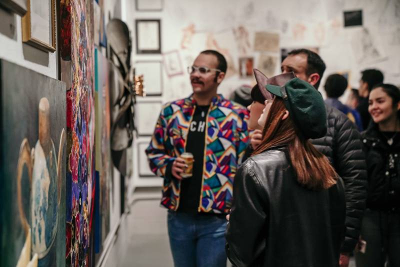 crowd of people observing art during the first friday art trail event in Lubbock