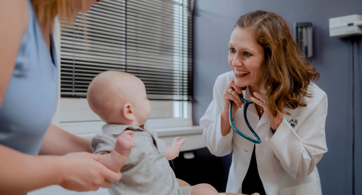 Pediatric doctor with child and mother