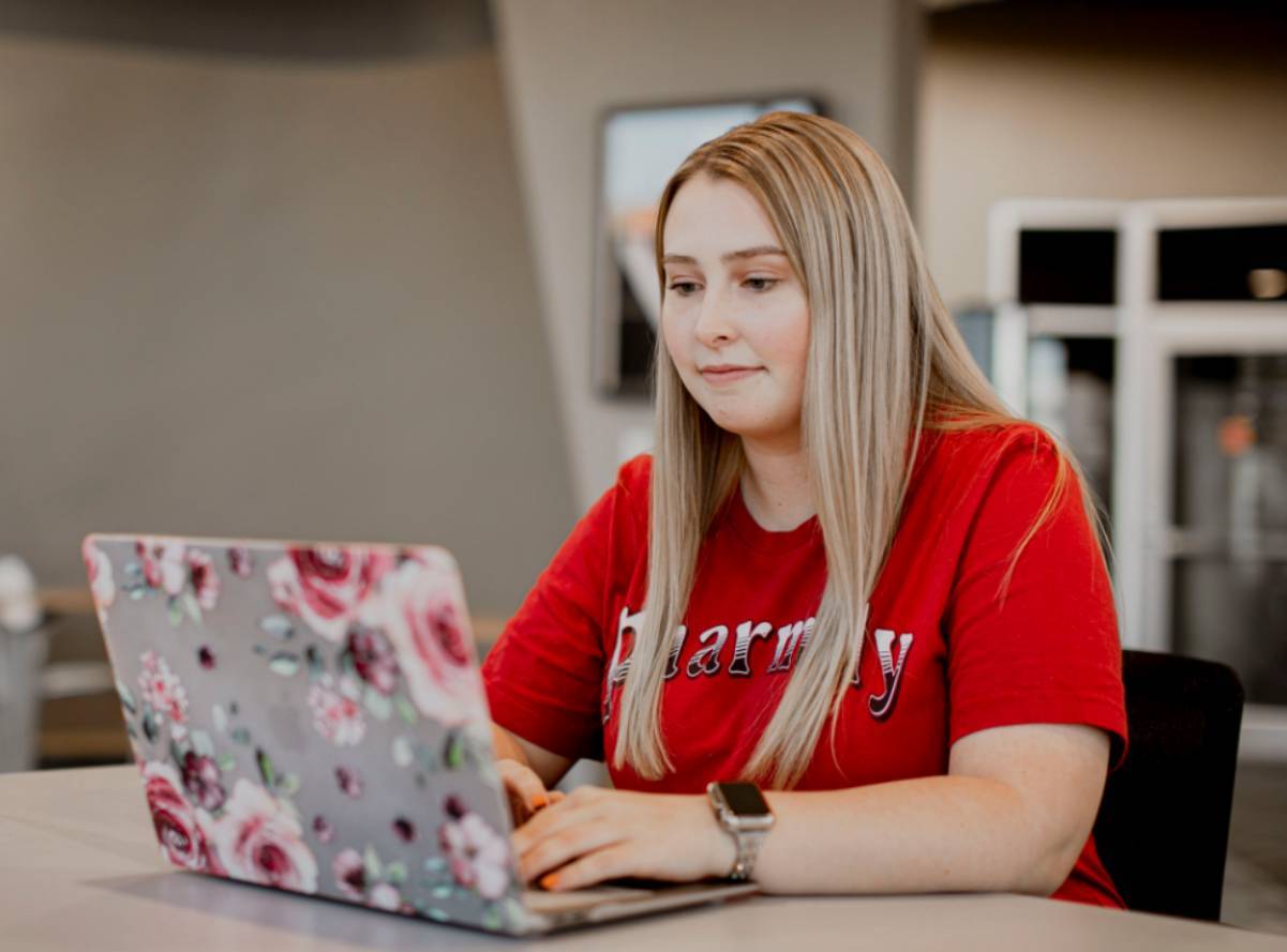 Student in lounge on laptop Student in lounge on laptop